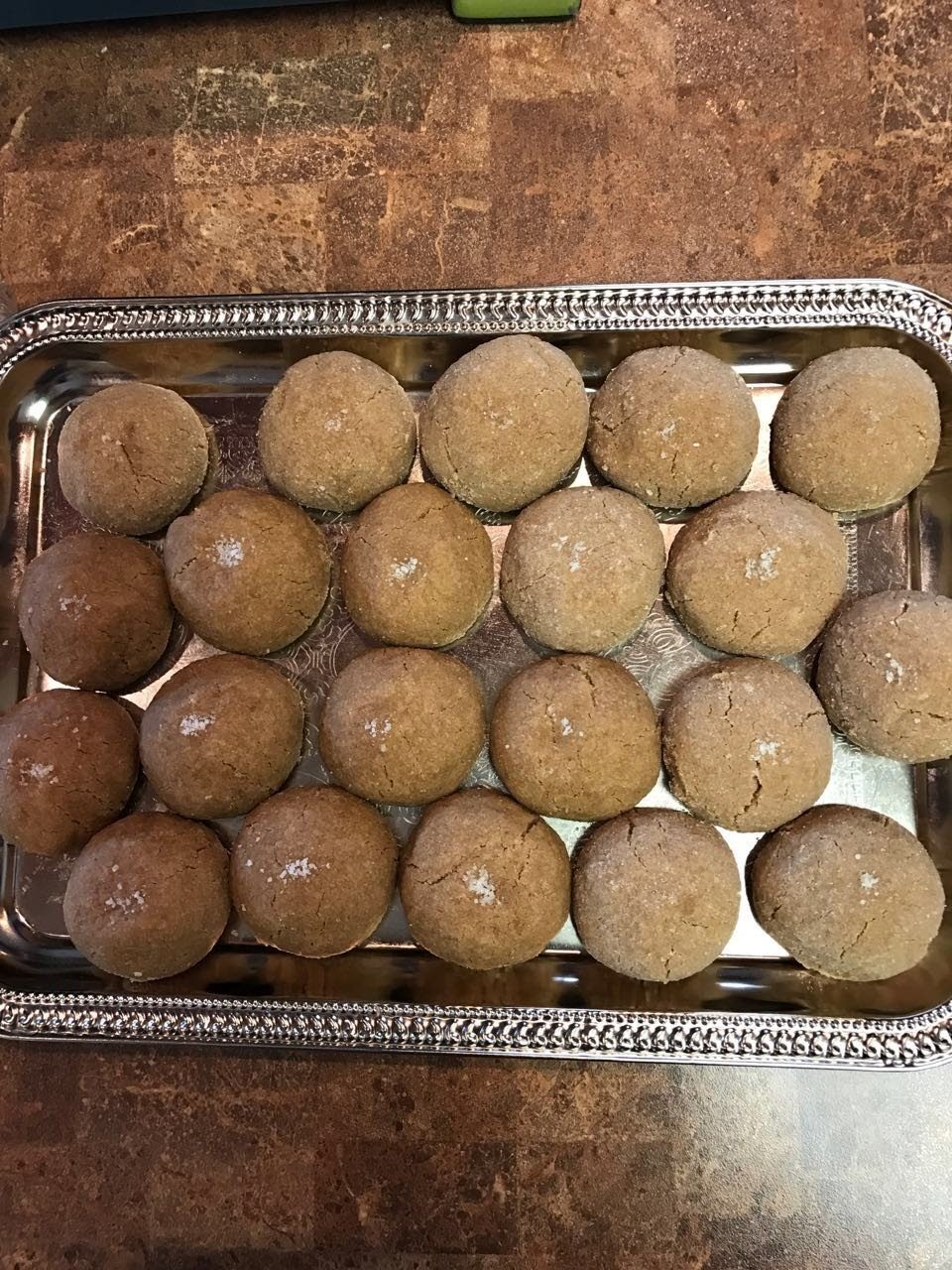 Sea salt brown butter cookies arranged on a silver tray