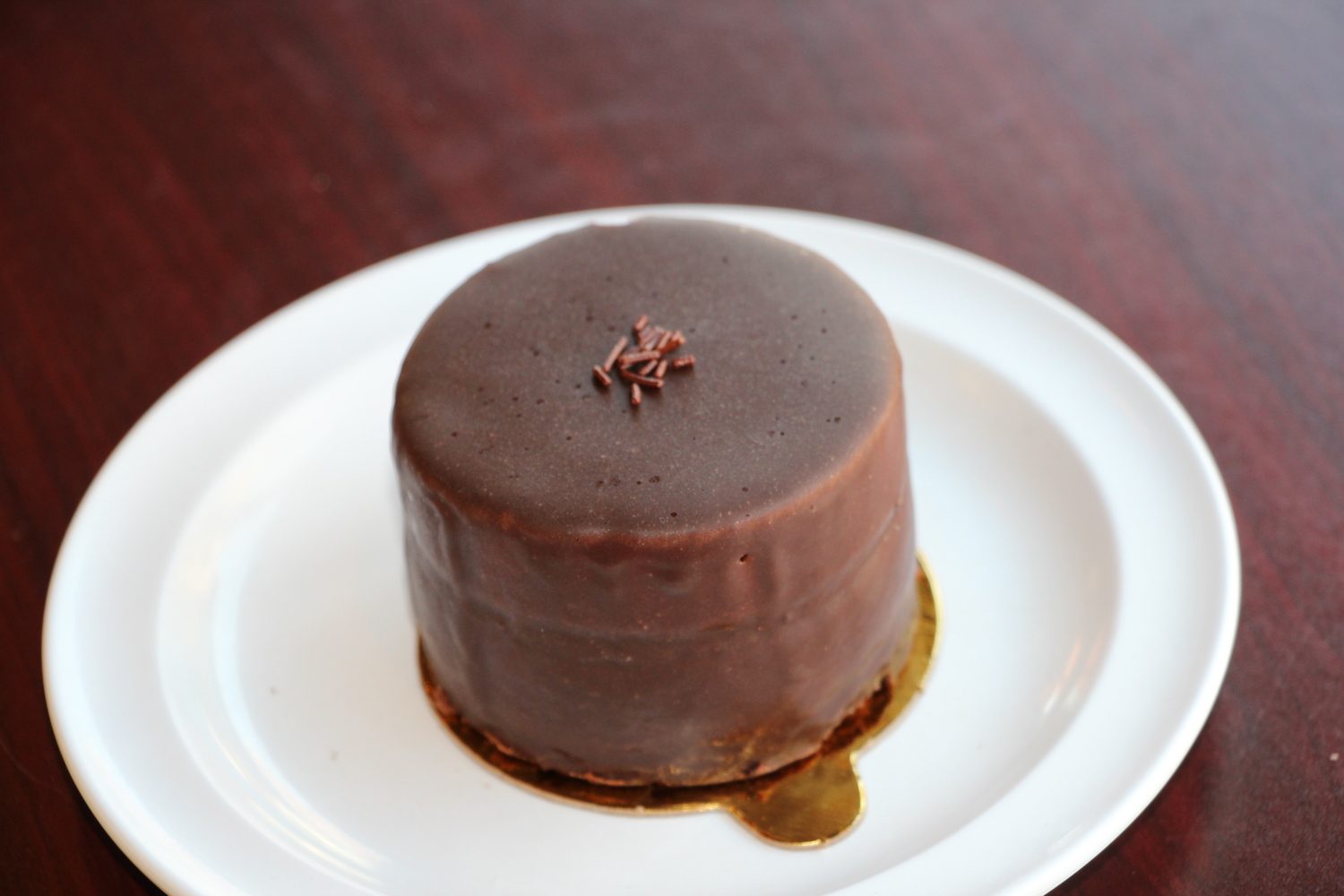 Chocolate mousse ganache under a smooth dark glaze