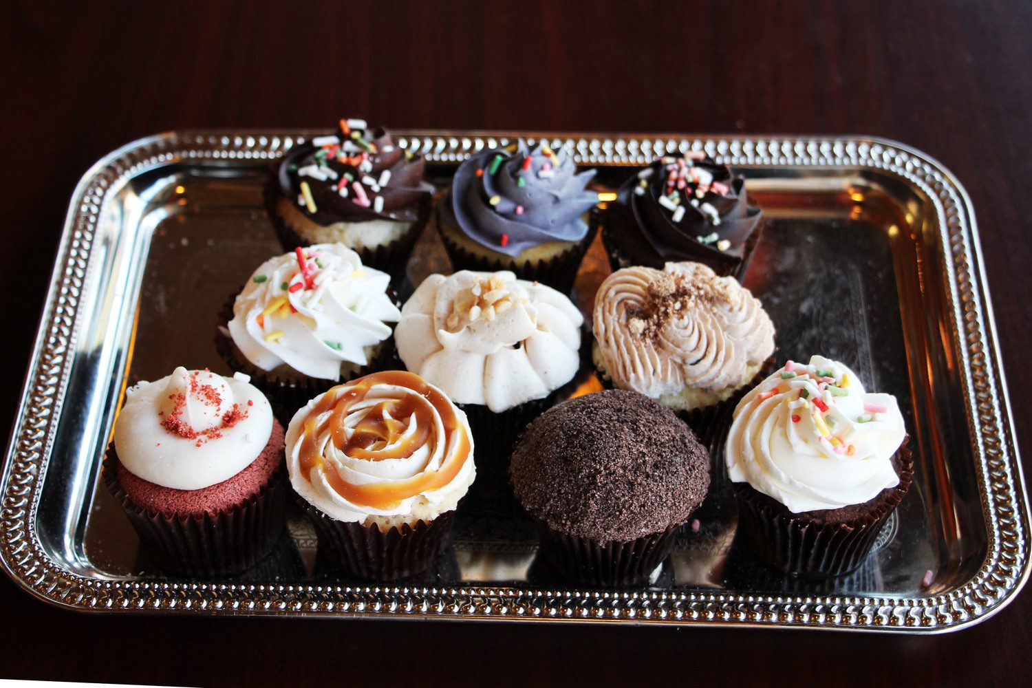 Small cupcakes arranged on a silver tray