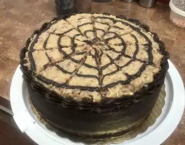 German chocolate cake with coconut pecan topping and piped chocolate lattice