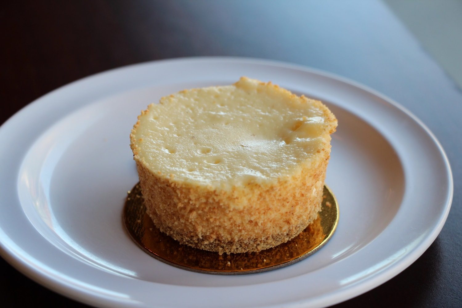 Plain cheesecake with a golden baked top and graham crumb crust