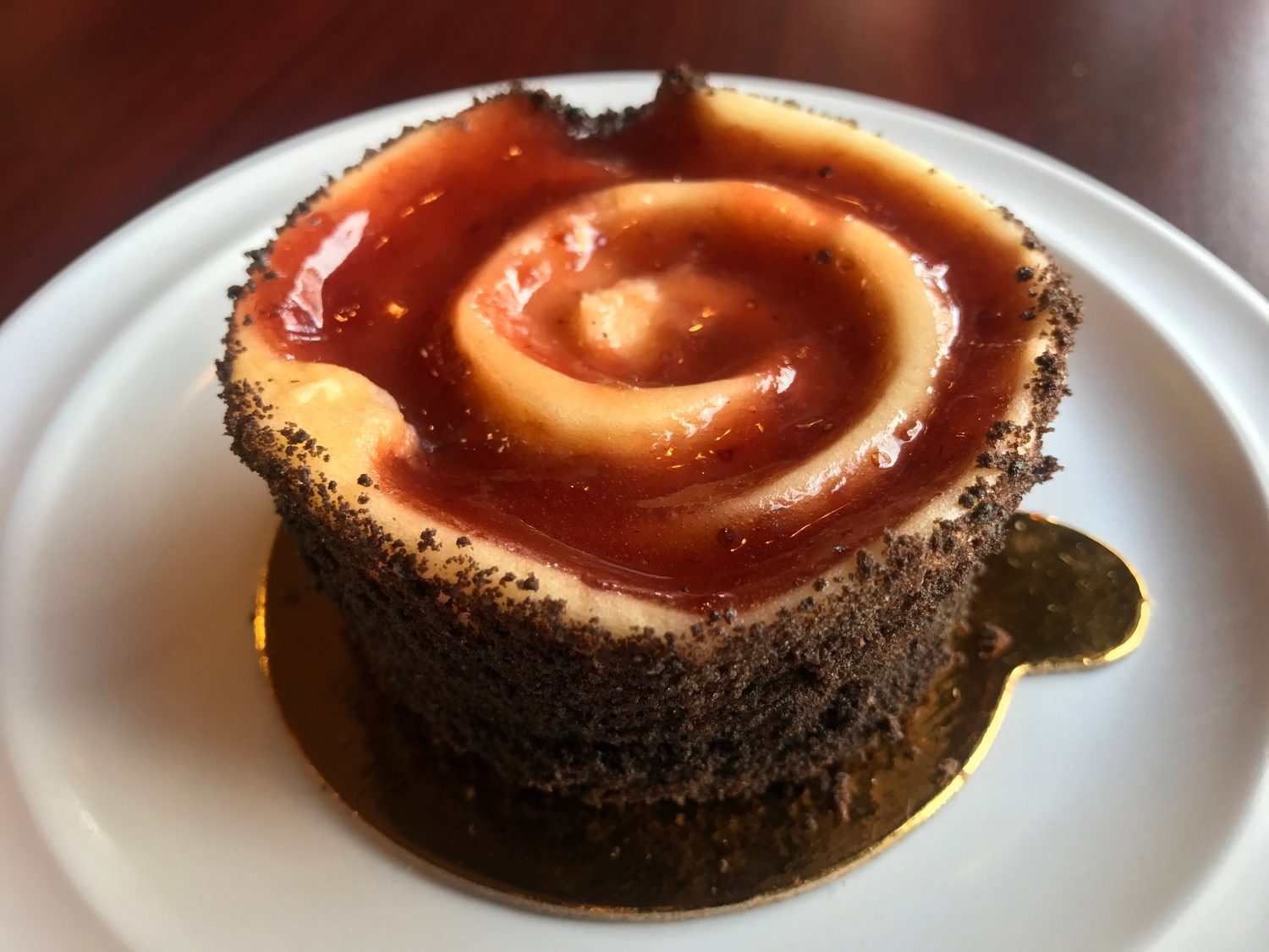 Strawberry swirl cheesecake with a glossy fruit spiral